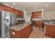 Spacious kitchen with granite countertops, stainless steel appliances, and rich wood cabinets at 3303 Ranchdale Dr, Plant City, FL 33566
