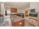 Open-concept kitchen with granite countertops and stainless steel appliances seamlessly connects to the living area at 3303 Ranchdale Dr, Plant City, FL 33566