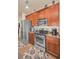 Cozy kitchen featuring stainless steel appliances and warm wood cabinets, creating an inviting culinary space at 3303 Ranchdale Dr, Plant City, FL 33566