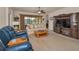 Inviting living room featuring comfortable seating, ceiling fan, and a large entertainment center at 3303 Ranchdale Dr, Plant City, FL 33566