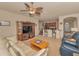 Cozy living room with a ceiling fan that flows into a modern kitchen, creating a welcoming and functional space at 3303 Ranchdale Dr, Plant City, FL 33566