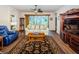 Inviting living room featuring hardwood floors, a ceiling fan, and ample natural light at 3303 Ranchdale Dr, Plant City, FL 33566