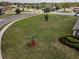 Aerial view of a large grassy lot featuring young trees with a street curving through the Eastridge Preserve neighborhood at 3303 Ranchdale Dr, Plant City, FL 33566