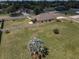 Wide aerial shot of a large grassy lot with a privacy fence and a few young trees at 3303 Ranchdale Dr, Plant City, FL 33566