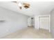 A calm, neutral-toned bedroom with carpeted floors and a ceiling fan fixture at 3553 34Th N Ave, St Petersburg, FL 33713