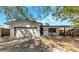 Charming single-story home with a brick facade, front porch, and an attached garage at 3553 34Th N Ave, St Petersburg, FL 33713