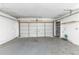 Spacious garage interior with a white door and painted floor at 3553 34Th N Ave, St Petersburg, FL 33713