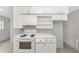 An efficiently arranged kitchen featuring white cabinetry and essential appliances for cooking at 3553 34Th N Ave, St Petersburg, FL 33713