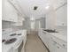 Compact kitchen with white cabinets, basic appliances, and functional layout at 3553 34Th N Ave, St Petersburg, FL 33713