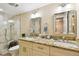 Bathroom with a granite countertop, dual sinks and framed mirrors over the toilet at 36750 Us Highway 19 N # 04138, Palm Harbor, FL 34684