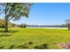 Expansive lake view with lush green lawn at 36750 Us Highway 19 N # 04138, Palm Harbor, FL 34684