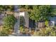Aerial view of a house with a dark roof surrounded by trees at 3902 E Henry Ave, Tampa, FL 33610