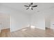 Bright bedroom with a ceiling fan, wood floors, walk-in closet, and white trim at 3902 E Henry Ave, Tampa, FL 33610
