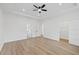 A spacious bedroom features wood floors, neutral walls, a ceiling fan, and an ensuite bathroom at 3902 E Henry Ave, Tampa, FL 33610