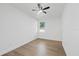 Bright bedroom with wood flooring, a ceiling fan, and a single window at 3902 E Henry Ave, Tampa, FL 33610