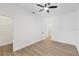 Bedroom with ceiling fan, wood floors, and open doors leading to other rooms at 3902 E Henry Ave, Tampa, FL 33610