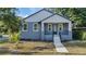 Charming blue two-story home with a welcoming front porch and landscaped front yard at 3902 E Henry Ave, Tampa, FL 33610