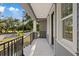 View from the cozy front porch with black iron railings and natural sunlight at 3902 E Henry Ave, Tampa, FL 33610