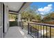 Spacious covered front porch offering relaxing outdoor living with black iron railings at 3902 E Henry Ave, Tampa, FL 33610