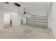 A clean, spacious garage has an automatic door opener and stairs to the main level at 3902 E Henry Ave, Tampa, FL 33610