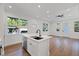 Open kitchen with a center island, a modern faucet, and lots of natural light at 3902 E Henry Ave, Tampa, FL 33610