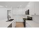 Modern kitchen with white cabinets, quartz countertops, and stainless steel appliances at 3902 E Henry Ave, Tampa, FL 33610