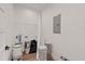 Utility room with paint cans, wire shelving, washer hookups, and electrical panel at 3902 E Henry Ave, Tampa, FL 33610