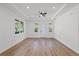 Spacious living room with tray ceiling, wood floors, and multiple windows at 3902 E Henry Ave, Tampa, FL 33610
