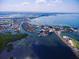 Breathtaking aerial view of waterfront property surrounded by bay and lush greenery, accessible by bridges at 3906 Versailles Dr, Tampa, FL 33634
