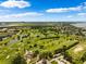 Stunning aerial view of lush golf course, lakes, and clubhouse in beautiful residential community near Tampa at 3906 Versailles Dr, Tampa, FL 33634