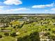 Scenic aerial view of a beautiful golf course with lakes surrounded by lush greenery and nearby residences at 3906 Versailles Dr, Tampa, FL 33634