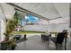 Cozy covered back patio with outdoor seating, lush greenery, and a peaceful ambiance at 3906 Versailles Dr, Tampa, FL 33634