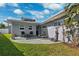 Backyard of home featuring outdoor shower, seating, and landscaping at 3906 Versailles Dr, Tampa, FL 33634