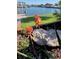 Picturesque backyard view with flower bed overlooking the canal, creating a serene waterfront setting at 3906 Versailles Dr, Tampa, FL 33634