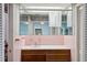 Retro bathroom features a vanity with pink tile backsplash and a large mirrored wall cabinet at 3906 Versailles Dr, Tampa, FL 33634