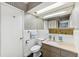 Retro bathroom features tiled walls, vanity, and unique decorative accents at 3906 Versailles Dr, Tampa, FL 33634