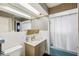 Bathroom with white tile, a shower with a curtain, and a vintage sink at 3906 Versailles Dr, Tampa, FL 33634