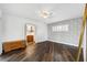 Spacious bedroom featuring hardwood floors, ceiling fan, and ensuite bathroom at 3906 Versailles Dr, Tampa, FL 33634
