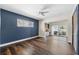 Bedroom with hardwood floors, a ceiling fan, a blue accent wall, and balcony access at 3906 Versailles Dr, Tampa, FL 33634