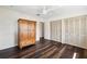 Bedroom boasts wood floors, a ceiling fan, and ample closet space at 3906 Versailles Dr, Tampa, FL 33634