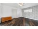 Bedroom with dark wood floors, floral wallpaper, and a closet at 3906 Versailles Dr, Tampa, FL 33634