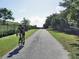 Scenic bike trail with a cyclist, surrounded by trees and greenery, ideal for outdoor recreation at 3906 Versailles Dr, Tampa, FL 33634