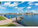 Dock extends into the water, providing a serene and picturesque waterfront living experience under blue sky at 3906 Versailles Dr, Tampa, FL 33634