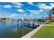 Dock overlooking calm water, perfect for boating and enjoying waterfront living, under a partly cloudy sky at 3906 Versailles Dr, Tampa, FL 33634