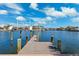 Private dock on tranquil water, offering access to waterfront activities and scenic views under a beautiful blue sky at 3906 Versailles Dr, Tampa, FL 33634