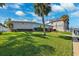 Charming single-story home with a large, well-maintained lawn, a dock and picturesque landscaping at 3906 Versailles Dr, Tampa, FL 33634