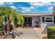 Inviting home exterior with manicured landscaping, featuring a modern front door with decorative glass panels at 3906 Versailles Dr, Tampa, FL 33634