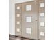 An interior shot of the front door with square windows at 3906 Versailles Dr, Tampa, FL 33634