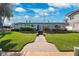 Well-manicured front yard with lush green grass and a charming walkway leading to the front door at 3906 Versailles Dr, Tampa, FL 33634
