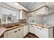 Functional kitchen with light-colored cabinetry, a copper sink, and a window overlooking the street at 3906 Versailles Dr, Tampa, FL 33634